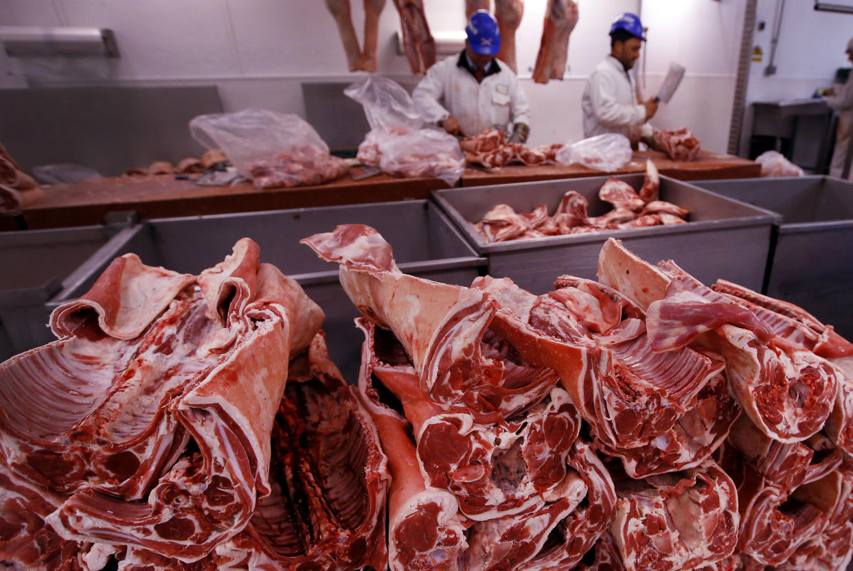 FILE - In this file photo taken on Monday, July 18, 2016, butchers prepare cuts of meat at Smithfield Market, in London.  A shortage of carbon dioxide in Europe is hitting food processing companies who rely on the gas to stun animals before slaughter, as it is announced Tuesday June 26, 2018, that some meat processing plants will run out of CO2 within days. (AP Photo/Kirsty Wigglesworth, FILE)