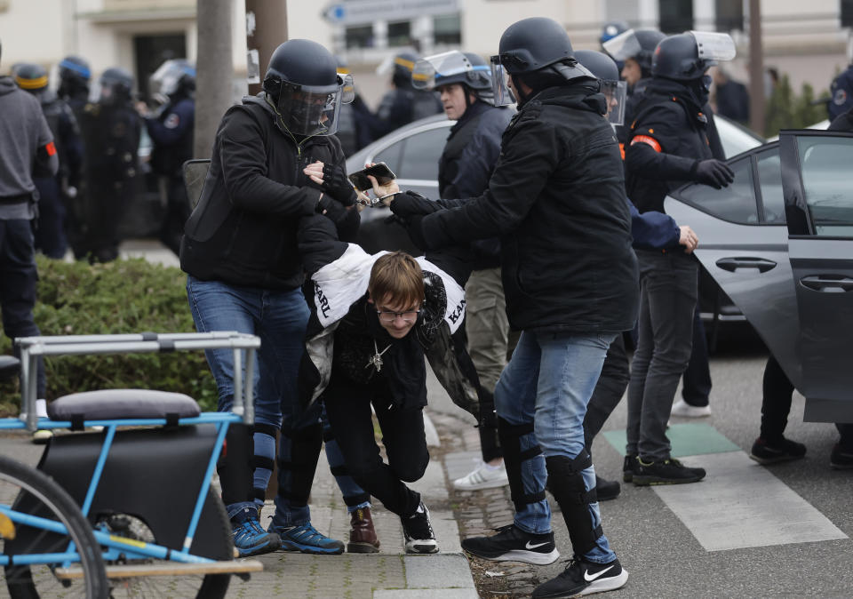 FILE - Police officers detain a protester during a rally in Strasbourg, eastern France, on March 23, 2023. French authorities see the police as protectors ensuring that citizens can peacefully protest President Emmanuel Macron’s contentious retirement age increase. But to human rights advocates and demonstrators who were clubbed or tear-gassed, officers have overstepped their mission. (AP Photo/Jean-Francois Badias, File)