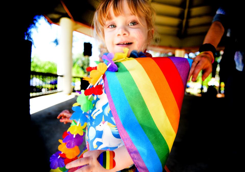 Brynn Bison looks into the camera as she dances during the Pride in the Park event Sunday morning, April 30, 2023, at Columbia Park. 