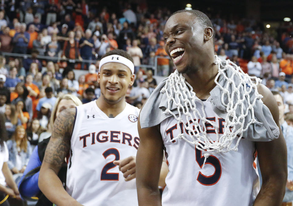 Auburn guard Mustapha Heron, right, celebrates after a victory against South Carolina on Saturday. (AP)