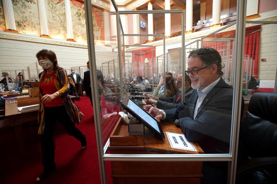 <span class="caption">When the Rhode Island General Assembly returned on June 17, 2020, plexiglass separated the desks as a coronavirus precaution. Republican Rep. Michael Chippendale was among members without a mask on.</span> <span class="attribution"><a class="link " href="https://www.gettyimages.com/detail/news-photo/providence-ri-6-17-2020-pictured-is-the-ri-house-chambers-a-news-photo/1221043872" rel="nofollow noopener" target="_blank" data-ylk="slk:Barry Chin/The Boston Globe via Getty Images;elm:context_link;itc:0;sec:content-canvas">Barry Chin/The Boston Globe via Getty Images</a></span>
