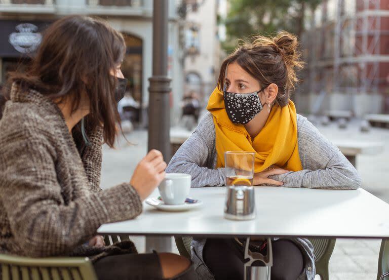 Dos mujeres comparten un café al aire libre en Madrid durante la pandemia de coronavirus