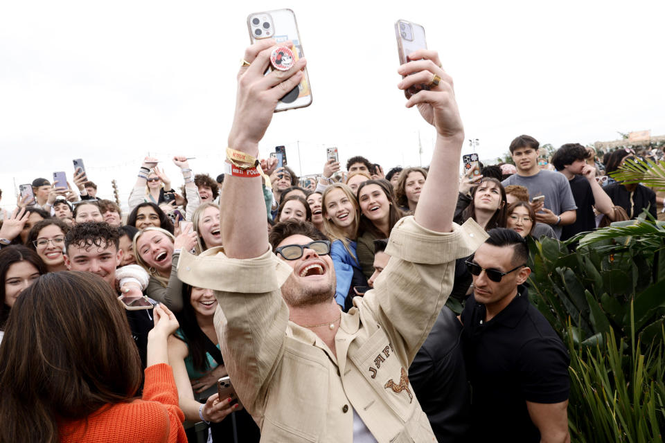 Chase Stokes (C) and guests attend Poguelandia: An Outer Banks Experience on February 18, 2023 in Huntington Beach, California. (Photo by Emma McIntyre/Getty Images for Netflix)