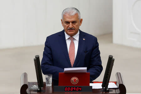 Turkey's new Prime Minister Binali Yildirim reads his government's programme at the Turkish parliament in Ankara, Turkey, May 24, 2016. REUTERS/Umit Bektas