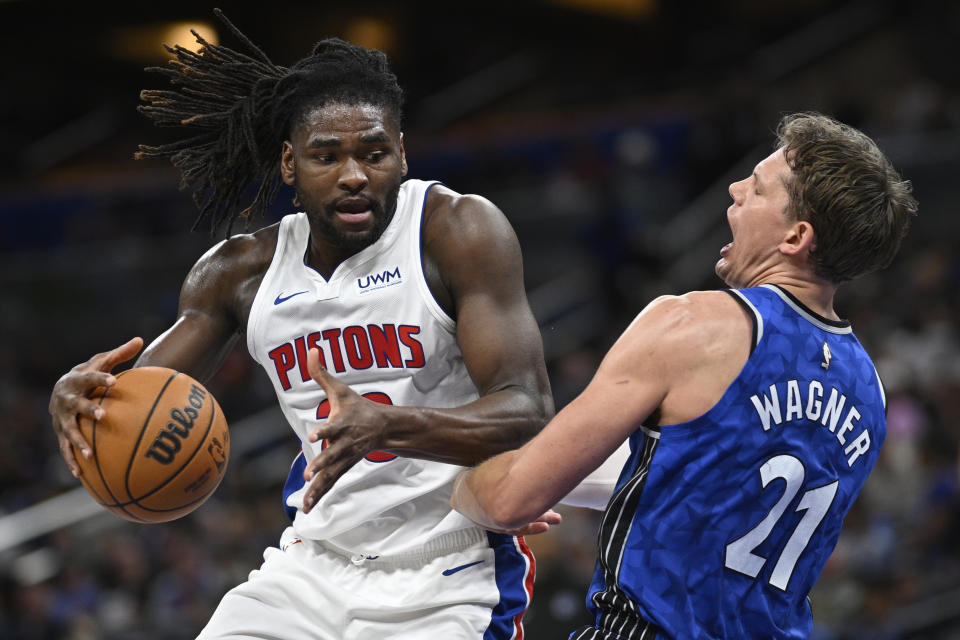 Detroit Pistons center Isaiah Stewart, left, drives to the basket as Orlando Magic center Moritz Wagner (21) defends during the first half of an NBA basketball game, Sunday, March 3, 2024, in Orlando, Fla. (AP Photo/Phelan M. Ebenhack)