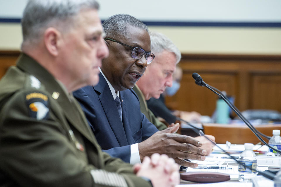 FILE - In this Wednesday, Sept. 29, 2021 file photo, from left, Chairman of the Joint Chiefs of Staff Gen. Mark Milley, Defense Secretary Lloyd Austin and Gen. Kenneth McKenzie, commander of the United States Central Command testify during the House Armed Services Committee on the conclusion of military operations in Afghanistan and plans for future counterterrorism operations on Capitol Hill in Washington. Congress is set to force America’s armed services to keep better track of their guns and explosives, imposing new rules in response to an Associated Press investigation that showed firearms stolen from U.S. bases have resurfaced in violent crimes. (Rod Lamkey/Pool via AP)