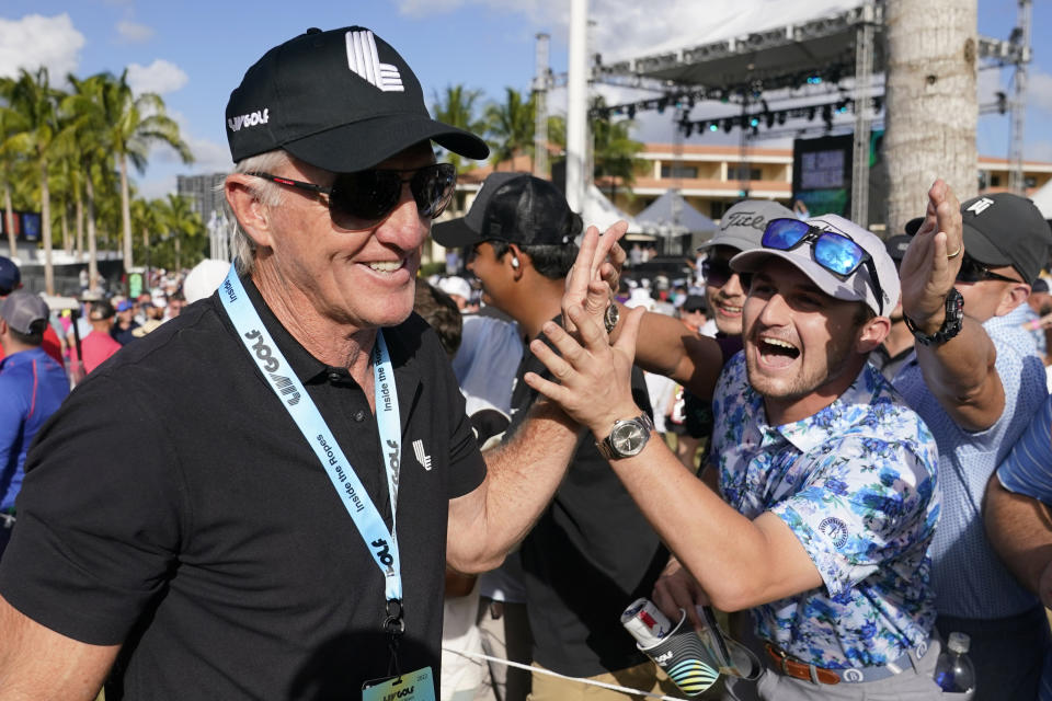 LIV Golf CEO Greg Norman, left, walks off the course after the final round of the LIV Golf Team Championship at Trump National Doral Golf Club, Sunday, Oct. 30, 2022, in Doral, Fla. (AP Photo/Lynne Sladky)