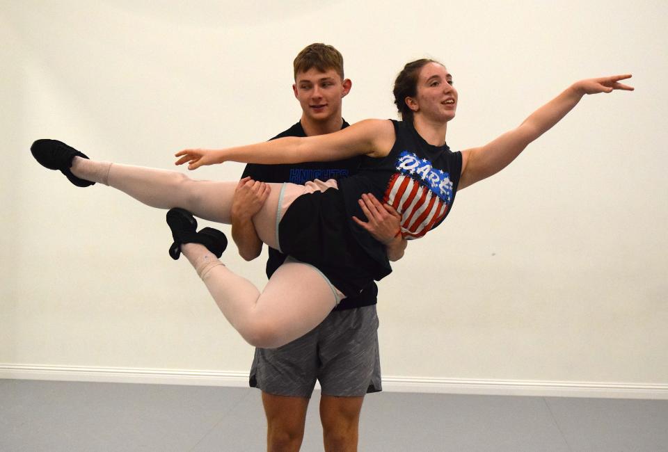 Instead of catching passes, Kyle Maltarich catches Chloe Mast as they prepare for the Artists & Athletes fundraising competition to be held Saturday, March 18, at Ohio Star Theater in Sugarcreek.