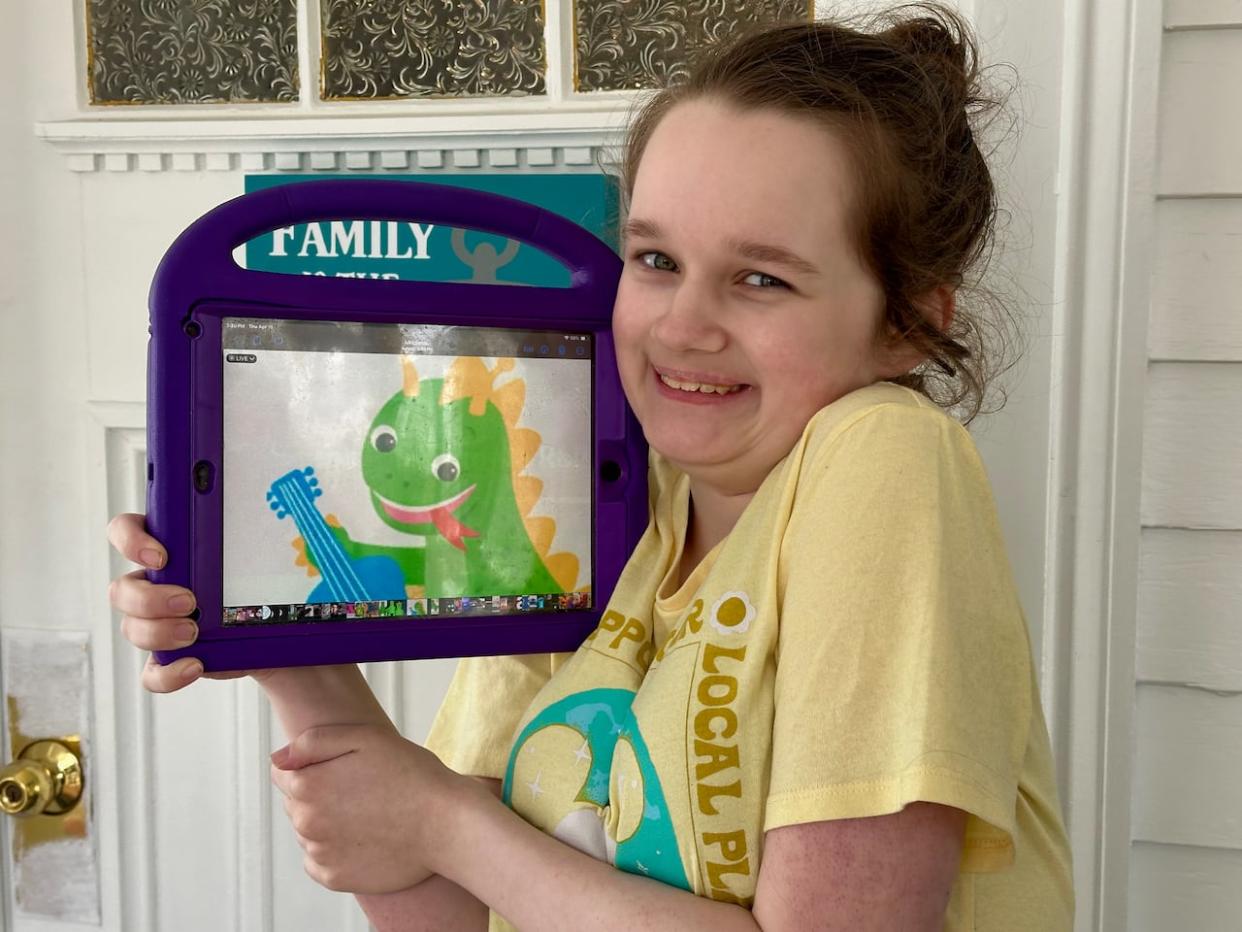 Rowan Squires, 12, posing with her cartoon friend, Bard the dragon outside her home in Middleton, N.S. (Dave Laughlin/CBC - image credit)