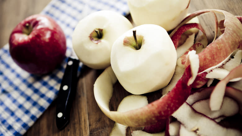 Apples and peels on a wooden table 