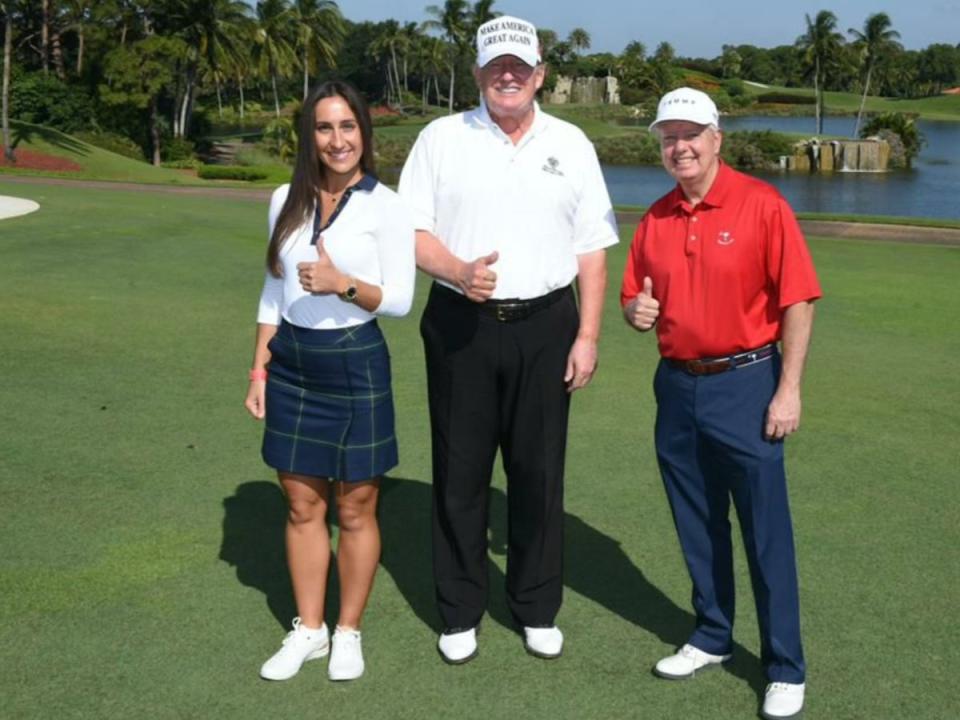 A woman going by the name ‘Anna de Rothschild’ — allegedly an alias used by Ukrainian-born Inna Yashchyshyn — posing with former President Donald Trump and Senator Lindsey Graham at Mar-a-Lago. (Pittsburgh Post Gazette/Organized Crime Corruption and Reporting Project)