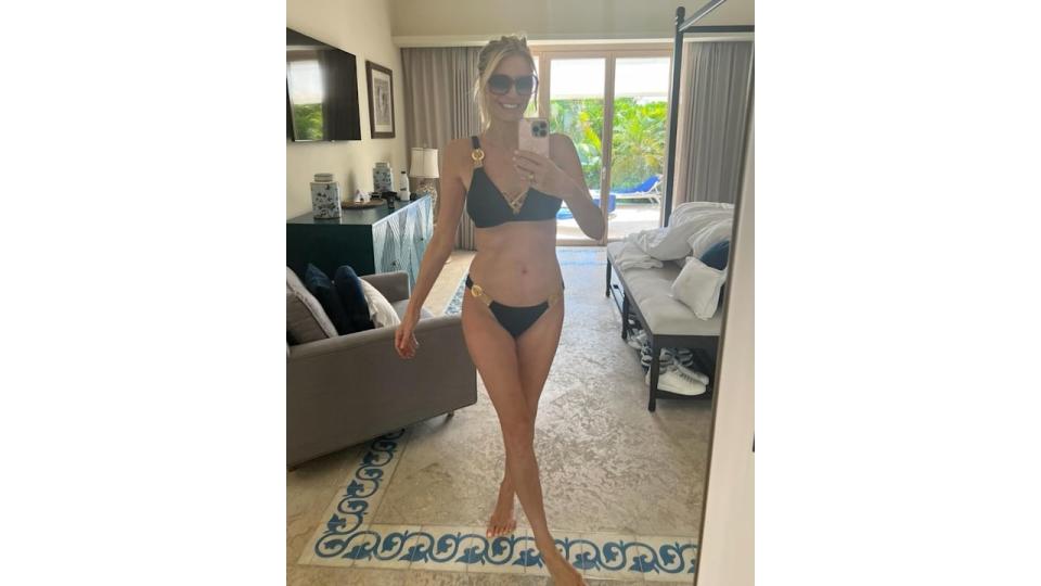 tess daly posing for mirror selfie in black bikini