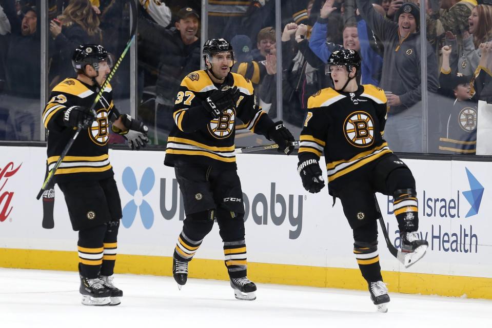 <p>
              Boston Bruins' Torey Krug (47) celebrates his game-winning goal with Patrice Bergeron (37) and Brad Marchand (63) in overtime during an NHL hockey game in Boston, Saturday, Nov. 23, 2019. (AP Photo/Michael Dwyer)
            </p>