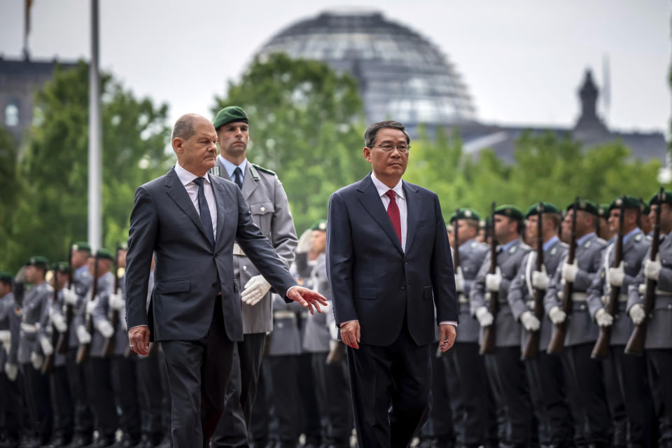 German Chancellor Olaf Scholz, left, receives Chinese Premier Li Qiang, right, with military honors for the German-Chinese government consultations, in front of the Federal Chancellery in Berlin, Germany, Tuesday June 20, 2023. (Michael Kappeler/dpa via AP)