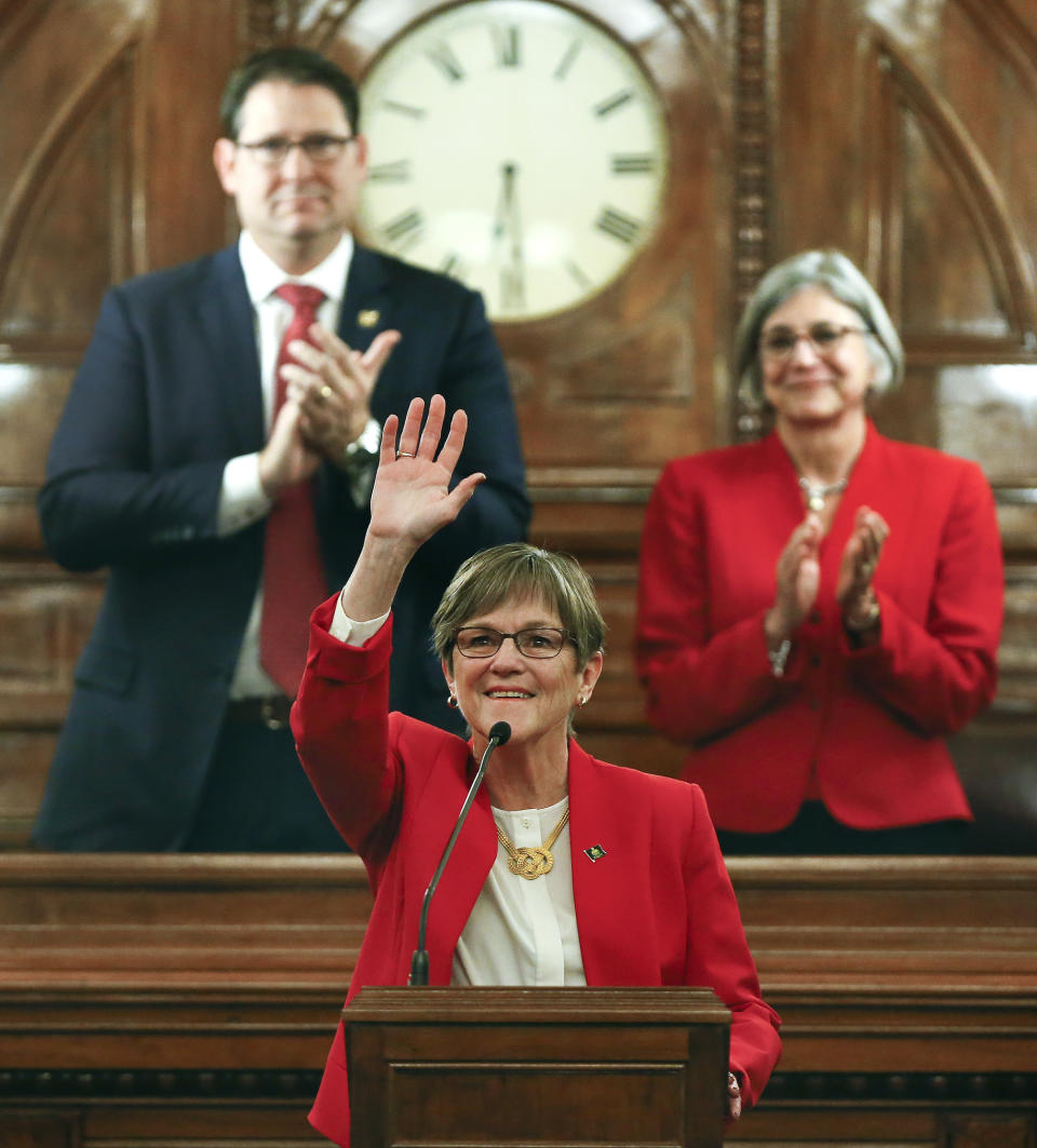 Kansas Gov. Laura Kelly waves to the crowd before giving her first State of the State address to lawmakers on the floor of the Kansas House on Wednesday, Jan. 16, 2019, in Topeka, Kan. (Chris Neal/The Topeka Capital-Journal via AP)