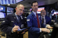 Trader Michael Urkonis. left, works with specialists John McNierney, center, and Douglas Johnson on the floor of the New York Stock Exchange, Friday, Nov. 9, 2018. Stocks are falling as energy companies are dragged lower by the continuing plunge in crude oil prices. (AP Photo/Richard Drew)