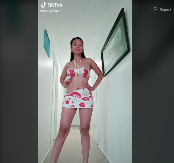 Woman poses in bikini and sarong made from Coles plastic reusable bags