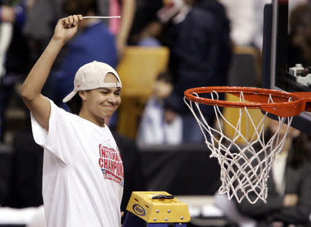 FILE PHOTO: The University of Maryland's Kristi Toliver celebrates by cutting down the net after Maryland defeated Duke University 78-75 in overtime to win the NCAA Women's Final Four national championship basketball game in Boston April 4, 2006. Toliver put the game into overtime with only seconds left in regulation time with a three point basket. REUTERS/Brian Snyder