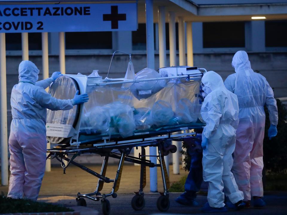 A patient in a biocontainment unit is carried on a stretcher at the Columbus Covid 2 Hospital in Rome, Monday, March 16, 2020.