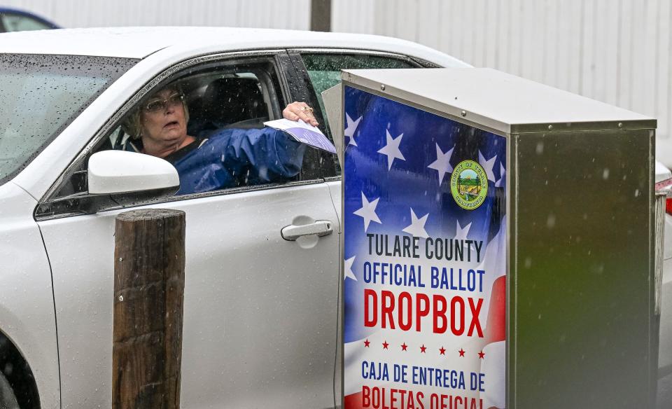 A little rain didn't keep voters from placing ballots in a Tulare County official ballot drop box Tuesday, November 8, 2022. This one is behind the Visalia Branch Library.