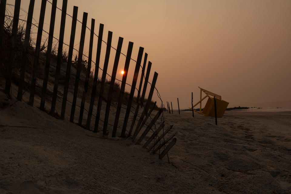 <p>The sun peaks through the haze and smoke from the Canadian wildfires on the beach on the Atlantic Ocean during sunrise in Lido beach, New York, U.S., June 8, 2023. REUTERS/Shannon Stapleton</p> 