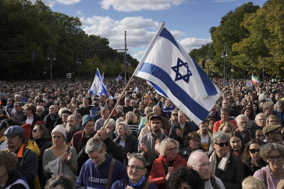People waves Israeli flags during a demonstration against antisemitism and to show solidarity with Israel in Berlin, Germany, Sunday, Oct. 22, 2023. (AP Photo/Markus Schreiber)