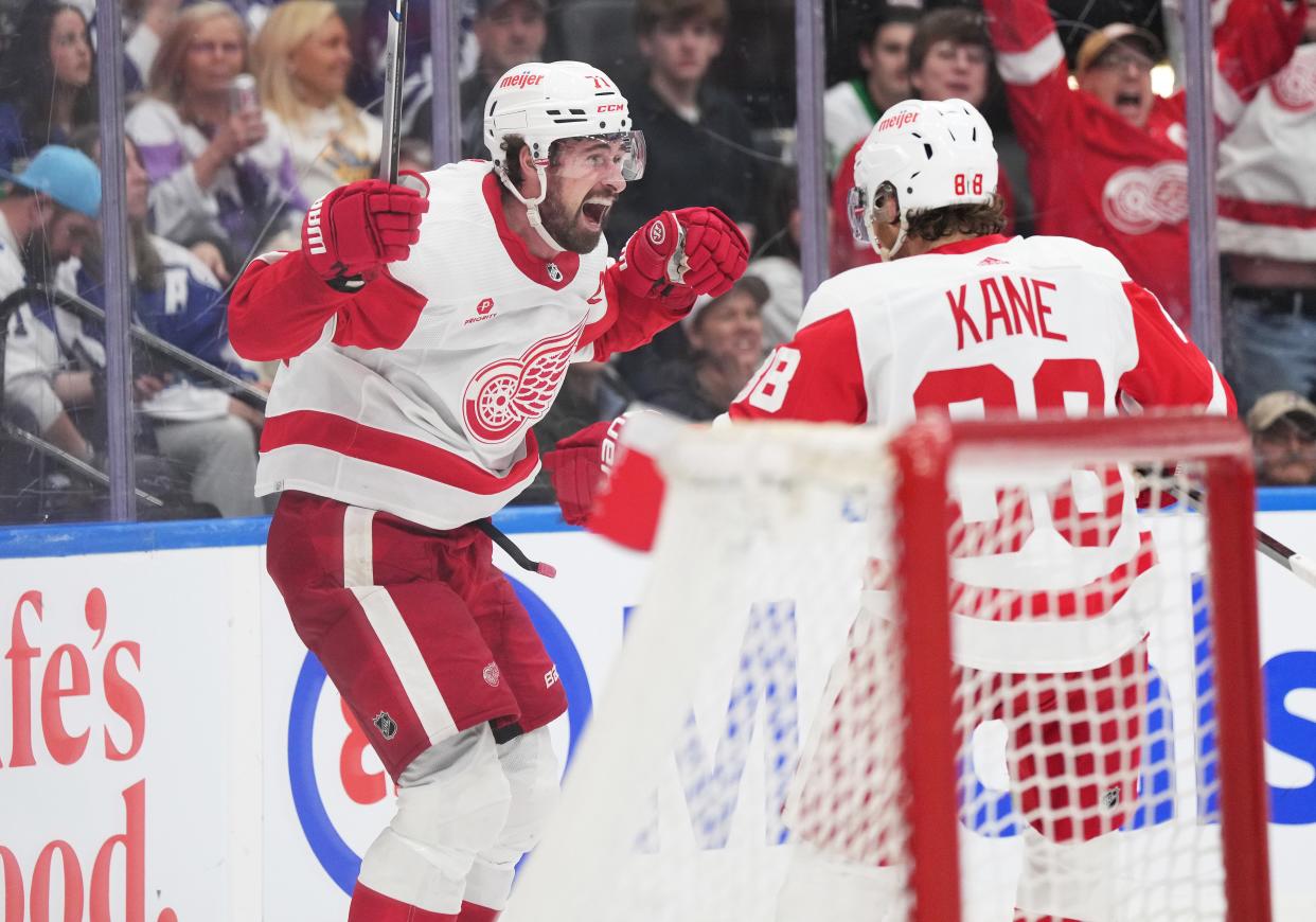 Detroit Red Wings center Dylan Larkin (71) scores the winning goal and celebrates with right wing Patrick Kane (88) against the Toronto Maple Leafs during the overtime period at Scotiabank Arena.