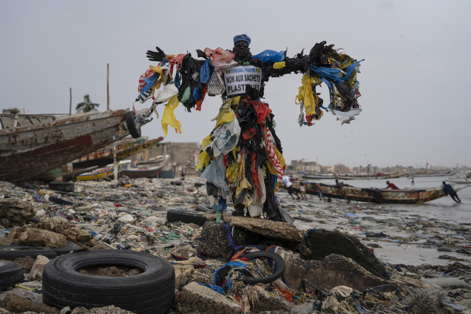 The environmental activist Modou Fall, who many simply call "Plastic Man", poses for a photo at the Yarakh Beach littered by trash and plastics in Dakar, Senegal, Tuesday, Nov. 8, 2022. Elections, coups, disease outbreaks and extreme weather are some of the main events that occurred across Africa in 2022. Experts say the climate crisis is hitting Africa “first and hardest.” Kevin Mugenya, a senior food security advisor for Mercy Corps said the continent of 54 countries and 1.3 billion people is facing “a catastrophic global food crisis” that “will worsen if actors do not act quickly.” (AP Photo/Leo Correa)