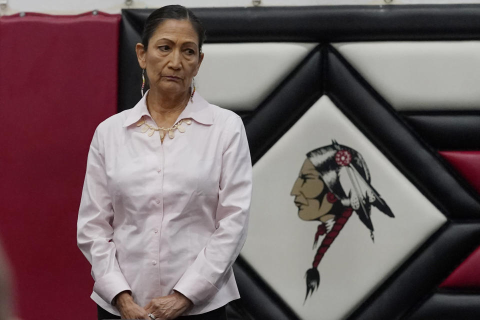 U.S. Secretary of the Interior Deb Haaland listens during ceremonies before a meeting to hear about the painful experiences of Native Americans who were sent to government-backed boarding schools designed to strip them of their cultural identities Saturday, July 9, 2022 in Anadarko, Okla. One by one, Native American tribal elders who were once students at government-backed Indian boarding schools testified about the hardships they endured: beatings, whippings, sexual assaults, forced haircuts and painful nicknames. (AP Photo/Sue Ogrocki)