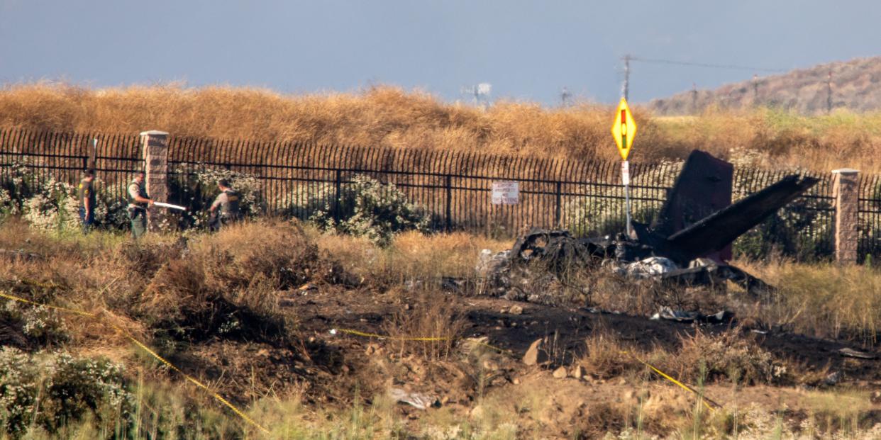 charred remains of a jet in dry yellow field