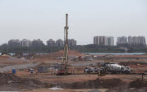 FILE - In this March 20, 2014, file photo, shot through a pane of glass shows a view of the Olympic Park under construction in Rio de Janeiro, Brazil. More than 2,000 construction workers were off the job Friday April 4, 2014, in the second day of a strike that has slowed work at the Olympic Park, the main cluster of venues for the 2016 Rio de Janeiro Games. (AP Photo/Silvia Izquierdo, File)