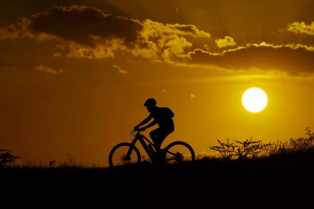 A cyclist tops a hill in San Antonio last month, when when temperatures continually hit triple digits.