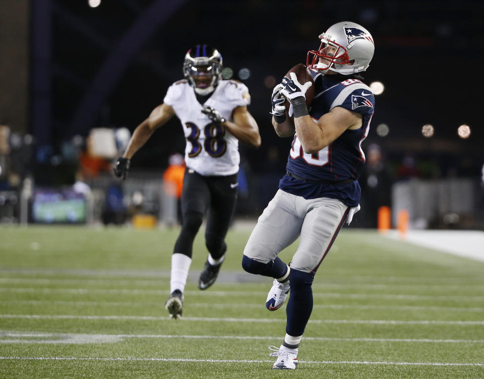 FILE - New England Patriots wide receiver Danny Amendola (80) catches a 51-yard touchdown pass from Julian Edelman, as he runs from Baltimore Ravens defensive back Rashaan Melvin (38) in the second half of an NFL divisional playoff football game on Jan. 10, 2015, in Foxborough, Mass. Amendola, who earned two Super Bowl rings with the Patriots and became one of Tom Brady’s favorite playmakers during his five seasons in New England, is retiring. (AP Photo/Elise Amendola, File)