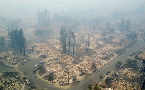 This aerial image shows a neighborhood that was destroyed by a wildfire in Santa Rosa - Credit: AP