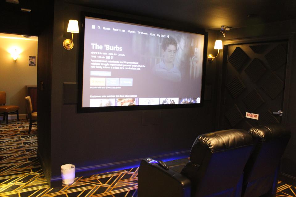 A movie plays on a 100-inch screen at Screen Suites in Akron. Luxury leather recliners and 7.2 Dolby digital surround sound make the movie experience complete.