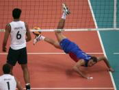 Russia's Taras Khtey (R) falls to the ground after failing to save a point as Brazil's Bruno Rezende (L) and Leandro Vissoto Neves look on during their men's Group B volleyball match against Brazil at the London 2012 Olympic Games at Earls Court July 31, 2012.