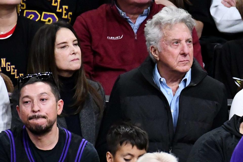 <p>Allen Berezovsky/Getty</p> Dustin Hoffman (R) and wife Lisa attend a Lakers vs. Knicks game at Crypto.com Arena on Dec. 18, 2023, in Los Angeles