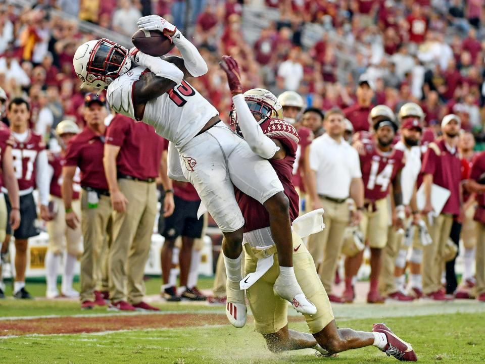 Sep 25, 2021; Tallahassee, Florida, USA; Louisville Cardinals defensive back Kei'Trel Clark (13) catches the game ending interception to win the game against the Florida State Seminoles at Doak S. Campbell Stadium. Mandatory Credit: Melina Myers-USA TODAY Sports