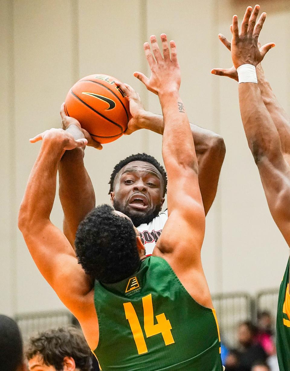 Brown's Tamenang Choh passes over the Vermont defense on Friday night.