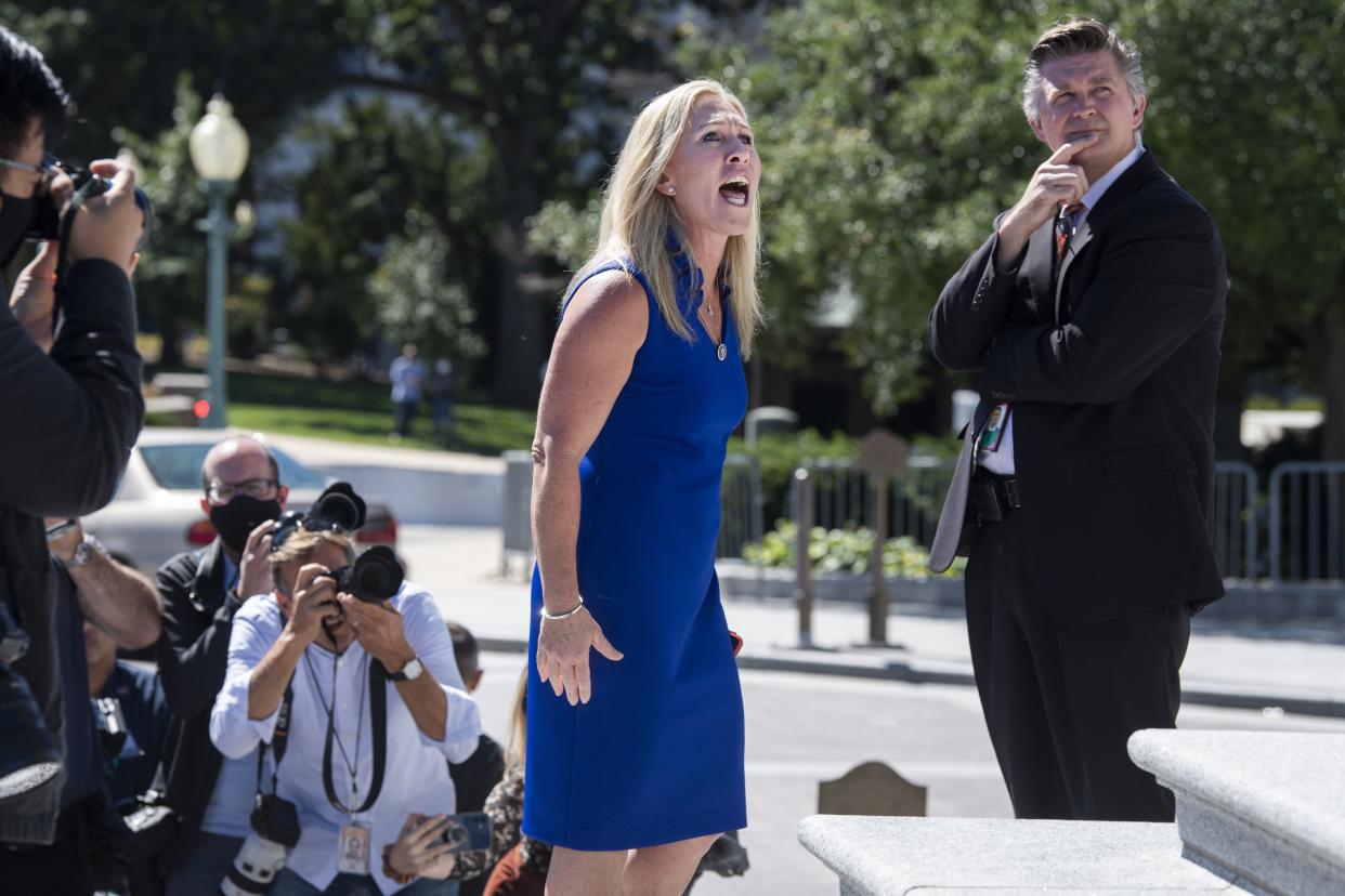 Rep. Marjorie Taylor Greene (R-Ga.) argues with Rep. Debbie Dingell, D-Mich., off camera, during a Build Back Better for Women rally held by Democrats on the House steps of the U.S. Capitol in Washington, D.C. on Friday, September 24, 2021 