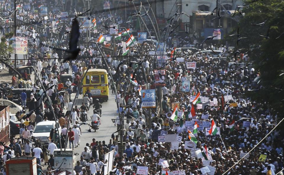 Indians march during a protest against the Citizenship Act in Mumbai, India, Wednesday, Dec. 18, 2019. India's Supreme Court on Wednesday postponed hearing pleas challenging the constitutionality of the new citizenship law that has sparked opposition and massive protests across the country. (AP Photo/Rajanish Kakade)