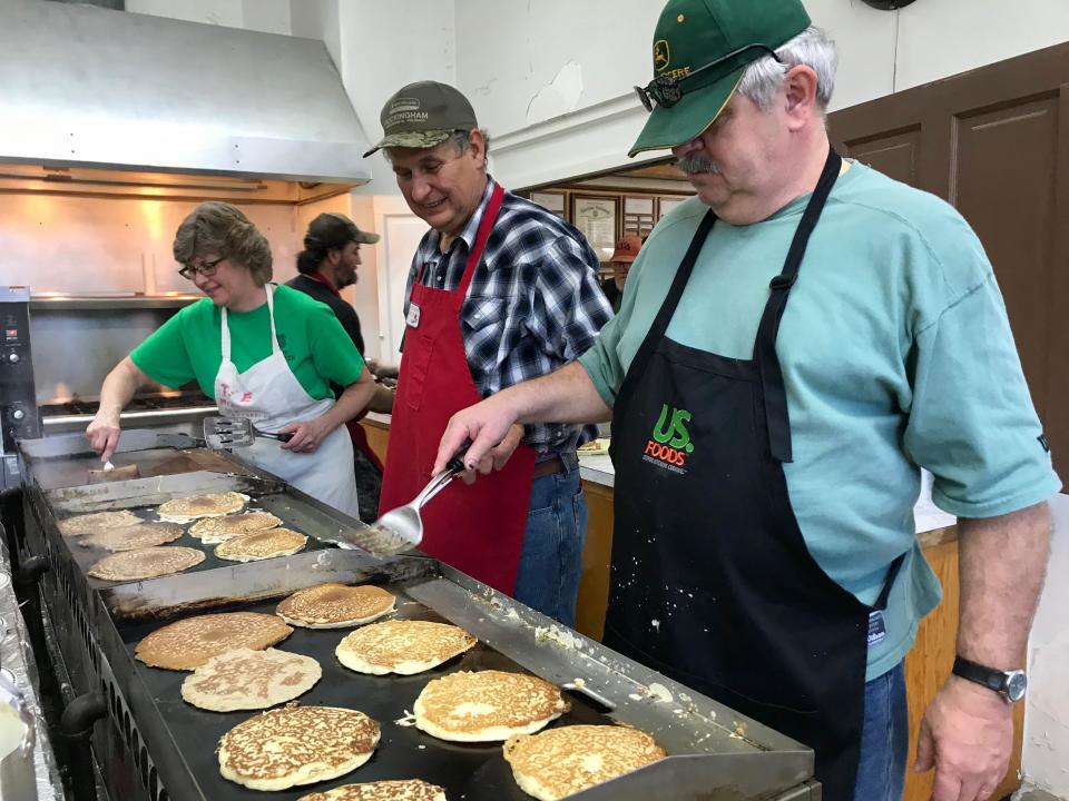 Kathy Beverage, Harry Sponaugle and Ronnie Hodge make pancakes at Stonewall Ruritan Club's all-you-can-eat buckwheat pancake breakfast at the McDowell Community Center during the 61st annual Virginia Highland Maple Festival on Sunday, March 17, 2019.