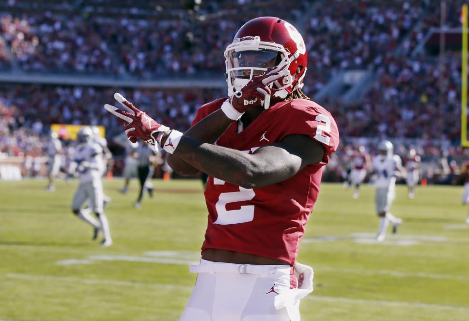 FILE - In this Oct. 27, 2018, file photo, Oklahoma wide receiver CeeDee Lamb (2) celebrates a touchdown during an NCAA college football game against Kansas State in Norman, Okla. Oklahoma quarterback Kyler Murray has star receivers in Marquise Brown and Lamb, yet he doesn’t hesitate to throw to other options.(AP Photo/Sue Ogrocki, File)