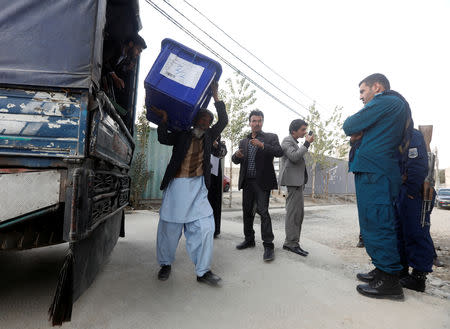 Afghan election commission unloads a ballot box with election material outside a polling station in Kabul, Afghanistan October 19, 2018. REUTERS/Omar Sobhani