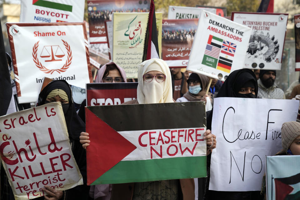 Pakistani people hold placards during a protest against Israeli airstrikes and to show solidarity with Palestinian people in Gaza, in Lahore, Pakistan, Saturday, Jan. 27, 2024. (AP Photo/K.M. Chaudary)