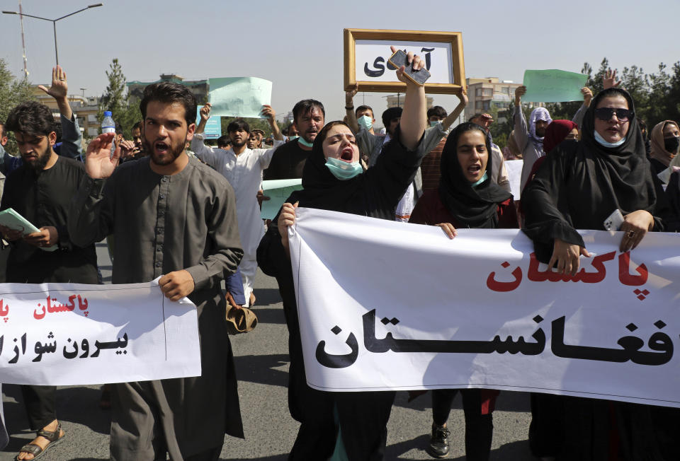 Afghans shout slogans during an anti-Pakistan demonstration, near the Pakistan embassy in Kabul, Afghanistan, Tuesday, Sept. 7, 2021. Signs in Persian read, "Pakistan Pakistan Get out of Afghanistan." (AP Photo/Wali Sabawoon)