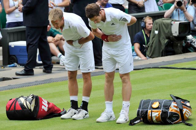 <p>David Ashdown/Getty </p> Andy Murray bows to Queen Elizabeth at Wimbledon 2010
