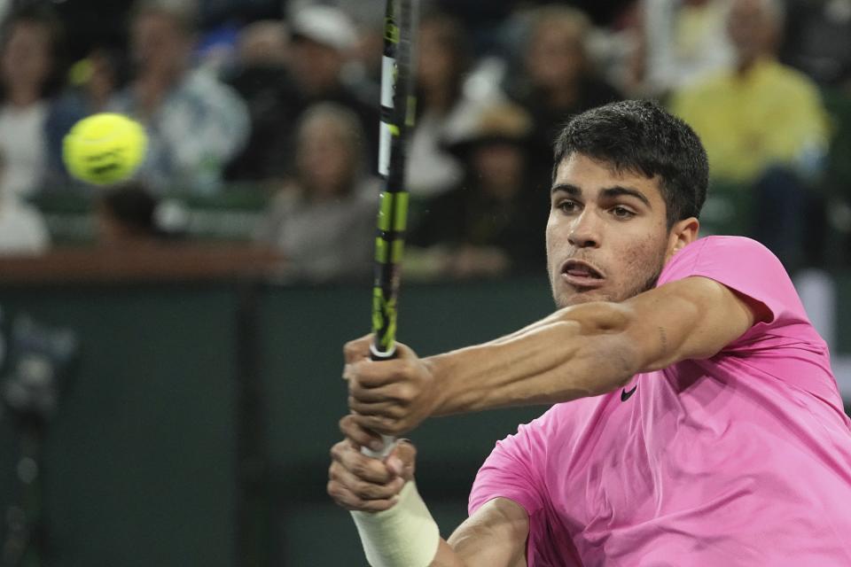 Carlos Alcaraz, of Spain, returns a shot to Thanasi Kokkinakis, of Australia, at the BNP Paribas Open tennis tournament Saturday, March 11, 2023, in Indian Wells, Calif. (AP Photo/Mark J. Terrill)