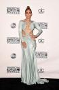 <p>Here's J.Lo looking like a damn goddess at the American Music Awards in a ballgown held together by thin straps that have us genuinely wondering how she even put it on?</p>