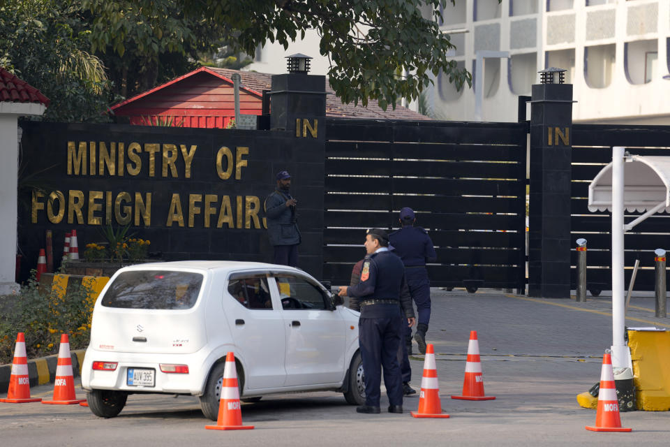 Police officers search a car at the main entry gate of Pakistan's Ministry of Foreign Affairs, in Islamabad, Pakistan, Thursday, Jan. 18, 2024. Pakistan's air force launched retaliatory airstrikes early Thursday on Iran allegedly targeting militant positions, an attack that killed at least several people and further raised tensions between the neighboring nations. (AP Photo/Anjum Naveed)